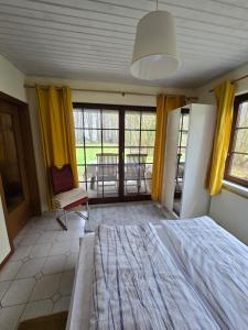 a bedroom with a bed and a table and chairs at Haus Seezeit in Plau am See