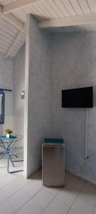 Habitación con mesa y TV en la pared. en Casa Giò en Las Terrenas