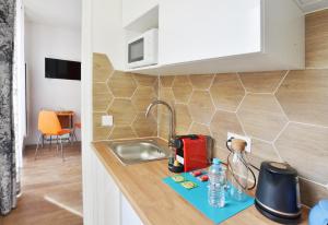 a kitchen with a sink and a counter top at Le Cocon de l'Orge RER Paris séjours au calme in Juvisy-sur-Orge