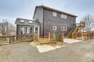 een huis met een houten hek en een terras bij Newly Renovated Maine Retreat Deck with Ocean View! in Lubec