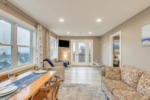 een woonkamer met een bank en een tafel bij Newly Renovated Maine Retreat Deck with Ocean View! in Lubec