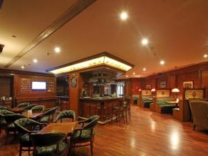 a restaurant with tables and chairs and a bar at Radisson Hotel Jalandhar in Jalandhar