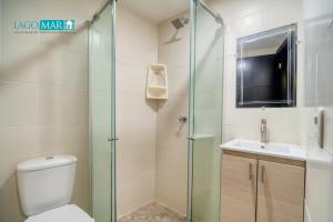 a bathroom with a shower and a toilet and a sink at Lagos y Mar Apartamentos Cartagena in Cartagena de Indias