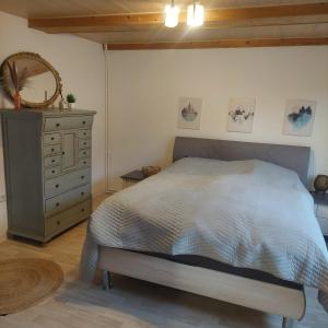 a bedroom with a large bed and a dresser at Günstige, moderne Zimmer im Wanderparadies in Wernigerode