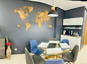 una sala da pranzo con tavolo e una mappa del mondo sul muro di Marin Beach Apartments Patacona a Valencia