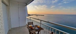 a balcony with a table and a view of the ocean at Sea of Dreams in Villajoyosa