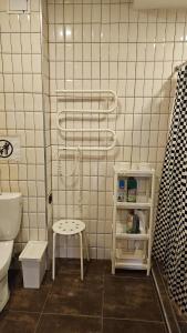 a bathroom with a toilet and a stool in it at Chocolate Hostel in Kaunas