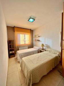 a bedroom with two beds and a window at Bungalow Steps from Moraira in Teulada +41 photos