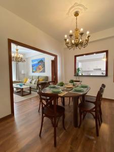 a dining room with a table and chairs and a chandelier at VISTA PLAZA - Exceptional Location in Los Llanos de Aridane