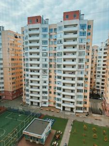 una pista de tenis frente a edificios altos en Family Apartment, en Chişinău