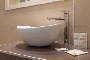 a white bowl sink on a counter in a bathroom at Hotel Hawaii Bed and Coffee in Riccione