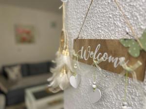 a wall with a sign that says welcome at Etno village Mihailovic in Herceg-Novi