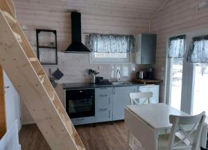 eine Küche mit einem Tisch und einem Herd Top-Backofen in der Unterkunft Gästehaus Lilla-Viken in Stöde