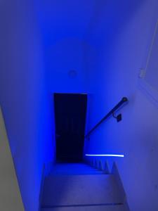 a blue room with stairs with a hand rail at G&M Home in Castellana Grotte +31 photos