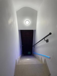 a stairway with a black door and a black hand rail at G&M Home in Castellana Grotte
