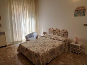 a bedroom with a bed and a chair and a window at Your Comfort Home - Bologna in Bologna