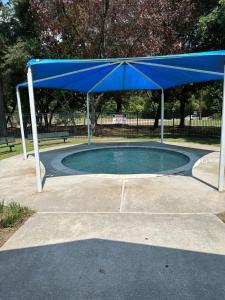 a blue cover over a pool of water at Unwind and Relax 4 Bedroom Stay in Humble