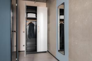a dressing room with a mirror and a closet at Daniel&Jacob's urban studios and boutique apartments in Aarhus