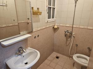 uma casa de banho com um lavatório, um WC e um espelho. em مدينة السلطان قابوس Sultan Qaboos city em Mascate