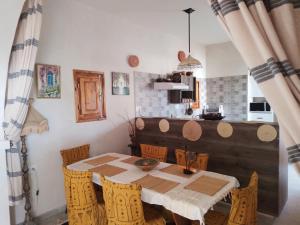 a dining room table and chairs in a kitchen at Djerba rêve vacances Noura in Midoun