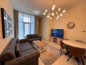 a living room with a couch and a table at Luxury apartment 3 beds Marina view in Dubai