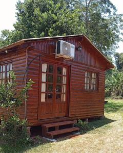 a small wooden cabin with a heater on top of it at Cabañas Aliwen in Puerto Bossetti