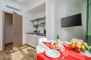 a dining room with a table with a bowl of fruit at Residenze Asproni Serviced Apartments in Cagliari