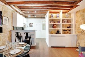 a kitchen and dining room with a table and chairs at MARAIS - VOSGES Luxury flat in Paris