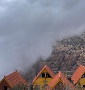 a group of houses in front of a mountain at Dana luxury huts in Dana
