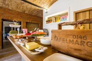 a counter with cheese and other foods on it at Chateau Nightingales in Hostouň