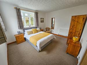 a bedroom with a bed and a window at Raphael House in Pembrey