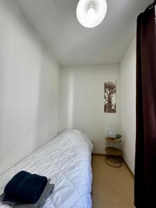 a white bedroom with a bed and a lamp at C13 Les Naïades - 2 bedrooms for 5 people ! in Avène