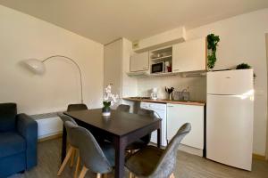 a kitchen and dining room with a table and chairs at Les Naïades C05- 2 bedrooms for 5 people ! in Avène