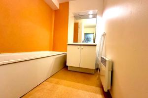 a bathroom with a bath tub and a mirror at C13 Les Naïades - 2 bedrooms for 5 people ! in Avène +7 photos