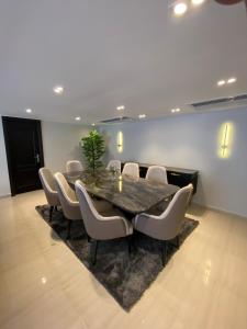 a conference room with a table and chairs at Luxurious Family 5BR Pool View Near Airport! in Cairo