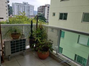 a balcony with potted plants on a building at Niterói e um pedacinho do Campo in Niterói