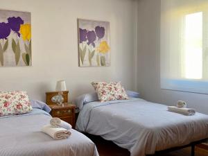 a room with two beds with towels on them at El Jardín de la Morena - Casco Histórico - VUT LE 1205 in León +51 photos