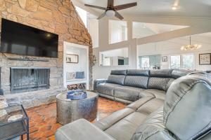 a living room with a couch and a fireplace at Spacious Vacation Rental with Grand Lake Views in Afton