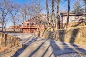 a house on the side of a road next to a wall at Spacious Vacation Rental with Grand Lake Views in Afton