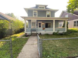 a blue house with a fence in front of it at 4BR 2BA Home in Charming St Paul - Sleeps 10 in Saint Paul