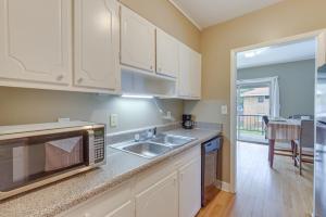 a kitchen with a sink and a microwave at Garden District Home Near Downtown Montgomery in Montgomery