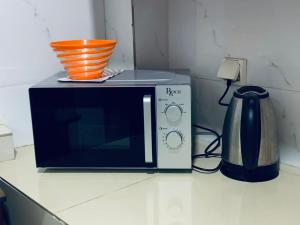a microwave sitting on top of a kitchen counter at Résidence 44 in Dakar