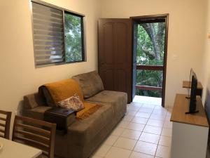 uma sala de estar com um sofá e uma mesa em Cabana com Vista para a Lagoa da Conceição RM9376 em Florianópolis