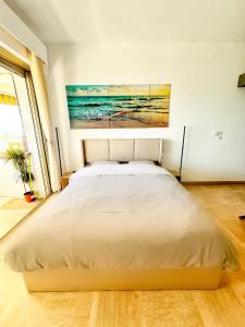 łóżko w sypialni z obrazem na ścianie w obiekcie #41 MARINA RIVIERA BAY - Marine Baie des Anges - Studio vue Mer et Port w mieście Villeneuve-Loubet