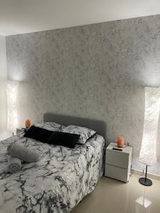 a bedroom with a bed and a wall at BY NEPTUNE - Appartement Disneyland Paris in Chessy