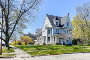 a white house with a gray roof at The Blacker House in Manistee