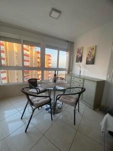 a dining room with a table and two chairs at Apartamento frente al mar in Torrox Costa