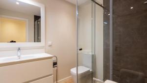 a bathroom with a toilet and a glass shower at Luxury and modern apartment in Porto Moniz center in Porto Moniz +29 photos