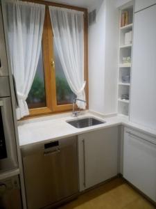 a kitchen with a sink and a window at Céntrica, espaciosa y cómoda in Getaria