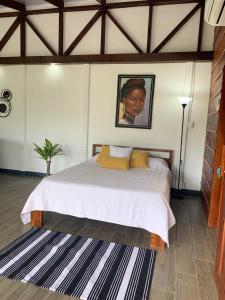 a bedroom with a bed and a painting on the wall at Studio 2327 in Pénjamo